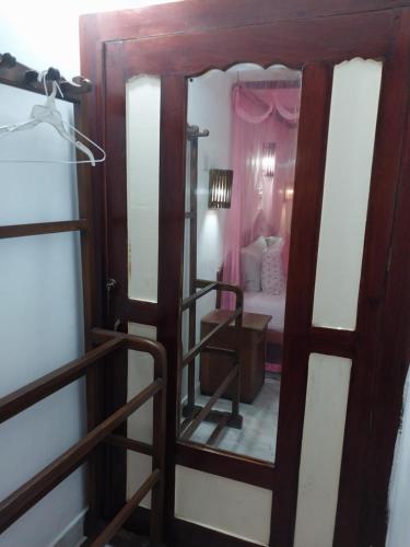 an open door to a bedroom with a mirror at Happy Night Holiday Inn in Unawatuna