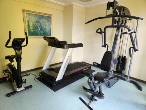 a gym with two exercise bikes and a treadmill at Hotel Casa do Amarelindo in Salvador