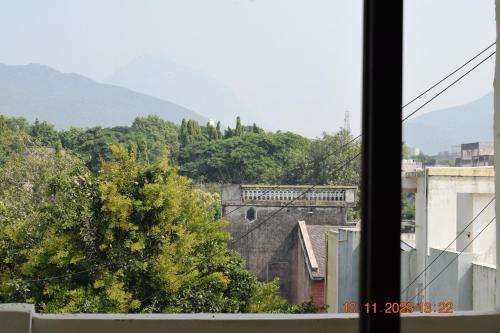a view of a city from a window at LEELA BIZOTEL in Junagadh