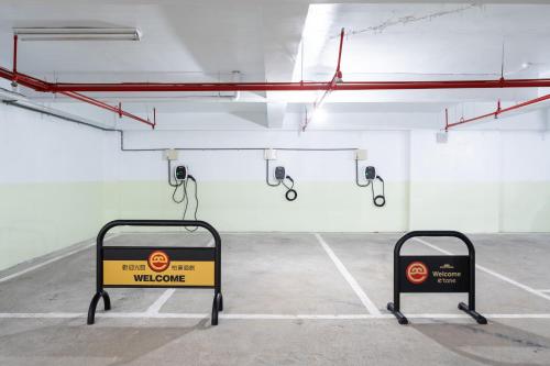 a parking lot with a welcome sign in a parking garage at Etung Hotel in Taichung