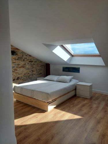 a bedroom with a bed and a skylight at SAN FRANCISCO in Ribadeo