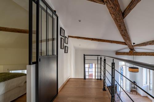 - une chambre avec un lit et un escalier dans l'établissement La Cathédrale de Bois, à Nîmes