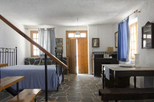 a bedroom with a bed and a table in it at Moorea Country Houses in Petalidhion