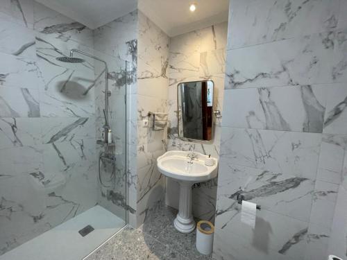 a white bathroom with a sink and a shower at Preciosa casa entre Lisboa, Cascais y Sintra in Fuente el Saz