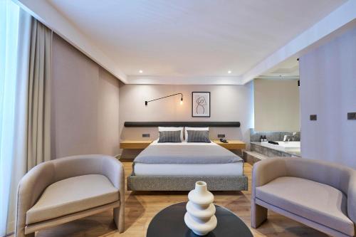a hotel room with a bed and two chairs at La Maja Hotel in Antalya