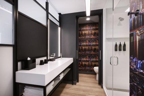 a bathroom with a sink and a wine cellar at Aloft Atlanta Perimeter Center in Sandy Springs