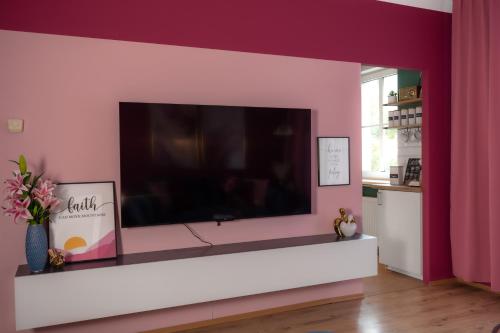 a living room with a large flat screen tv on a wall at Designer Luxury Apartment near Prater in Vienna