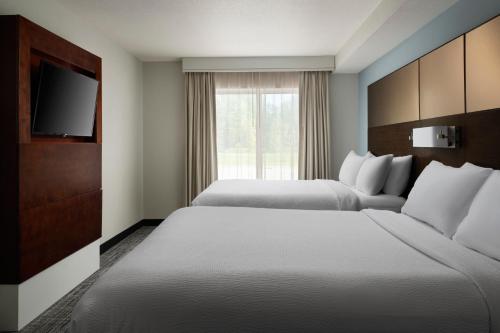 a hotel room with two beds and a television at Residence Inn by Marriott Green Bay Downtown in Green Bay