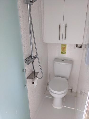 a small bathroom with a toilet and a white cabinet at Military Shepherd Hut in Haxey