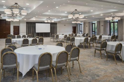 a conference room with tables and chairs and a screen at Delta Hotels by Marriott Liverpool City Centre in Liverpool