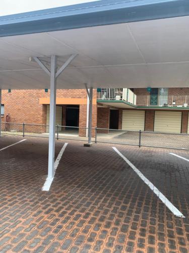 an empty parking lot in front of a building at The Bay Beach Shack, Hervey Bay in Hervey Bay