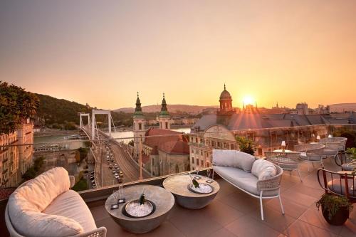 a balcony with couches and a view of a city at Matild Palace, a Luxury Collection Hotel in Budapest