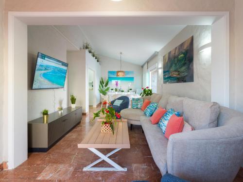 a living room with a couch and a table at El Veril by CanariasGetaway in San Agustin