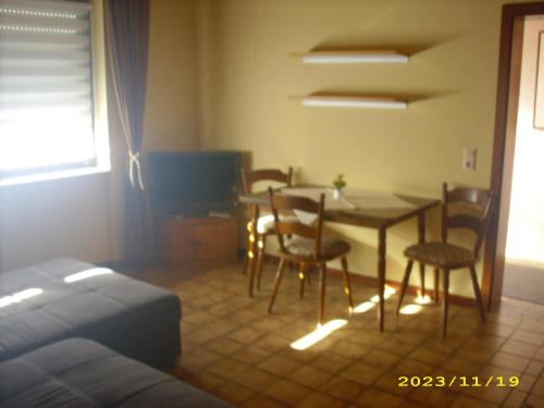 a room with a dining room table and chairs at Hotel Europa in Holsthum