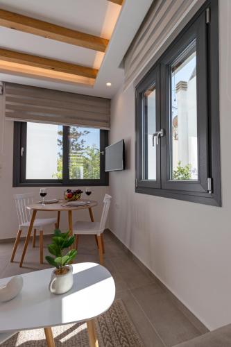 a living room with a table and two windows at Juliano luxury apartments, port of Naxos in Naxos Chora