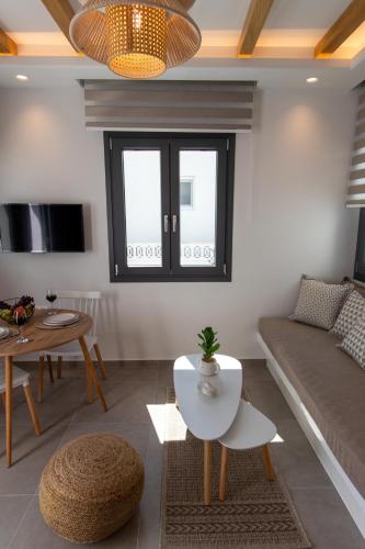 a living room with a couch and a table at Juliano luxury apartments, port of Naxos in Naxos Chora