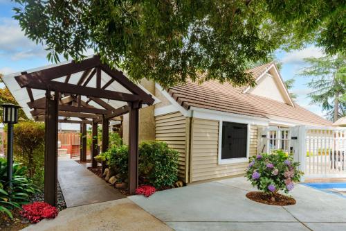 a pergola in front of a house at Residence Inn San Jose Campbell in Campbell