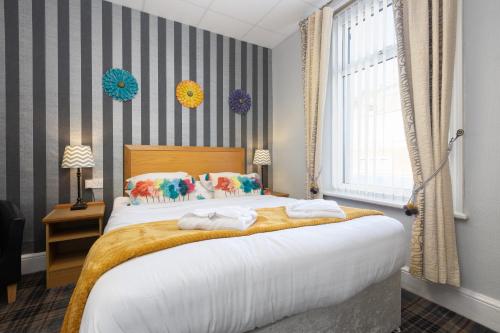 a bedroom with a large bed and a window at Adelaide Lodge - Town Centre - Opposite Winter Gardens in Blackpool
