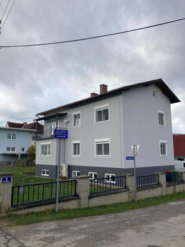 a white building on the side of a street at Ferienwohnung "Wohnung in Haus" in Neunkirchen