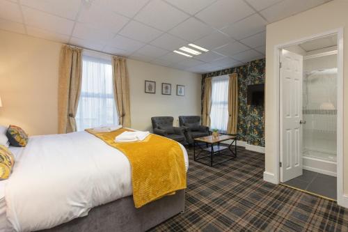 a hotel room with a bed and a chair at Adelaide Lodge - Town Centre - Opposite Winter Gardens in Blackpool