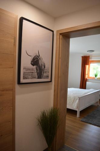 a picture of an elephant on a wall in a bedroom at Vier-Zimmer-Wohnung mit Garten zwischen Salzburg und Königssee in Ainring