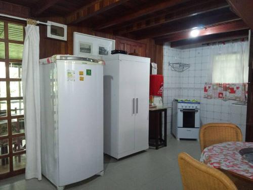 eine Küche mit zwei weißen Kühlschränken in einem Zimmer in der Unterkunft Chalé de Madeira nr03 - Exuberante Flora e Fauna - IMBASSAI in Mata de Sao Joao