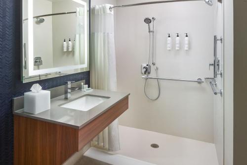 a bathroom with a sink and a shower at Fairfield Inn & Suites Atlanta McDonough in McDonough