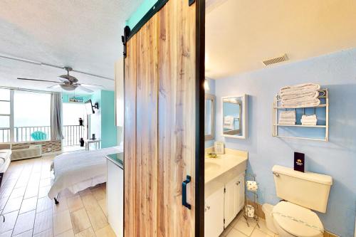 a bathroom with a door leading to a bedroom at Daytona Beach Club 708 in Daytona Beach