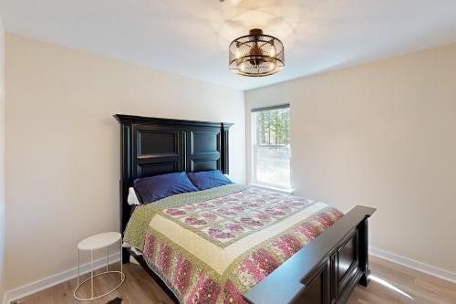 a bedroom with a bed and a window at Holly Lake Ranch Retreat in Rhonesboro