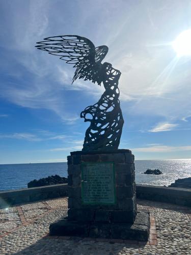 a statue of a bird on the beach at SummerHouse in Mazzeo