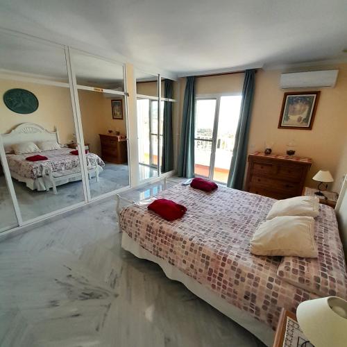 a bedroom with a bed and a large mirror at Villa Angie in Nerja