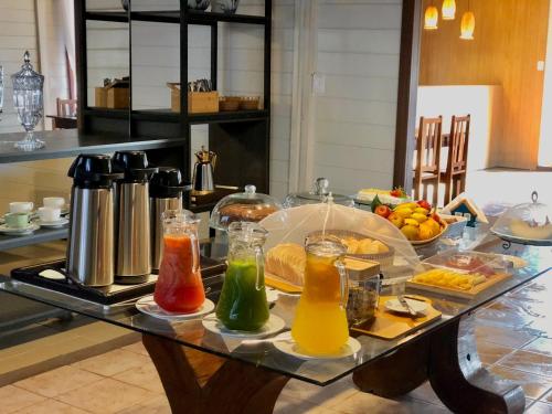a table with different types of drinks on it at Pousada Jardins in Santarém