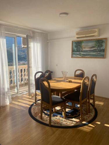 a dining room with a wooden table and chairs at Apartman Bilanovic in Konjic