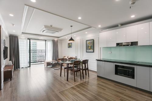 a kitchen and living room with a table and chairs at D'LEROI SOLEIL- TAY HO- NEAR WESTLAKE IN HA Noi in Hanoi