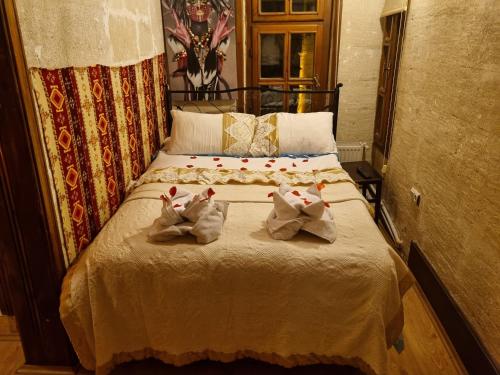 a bedroom with a bed with two towels on it at Born Hotel in Urgup