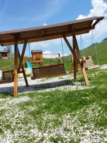a swing set in a field of flowers at Hotel Sole del Baldo in Brentonico