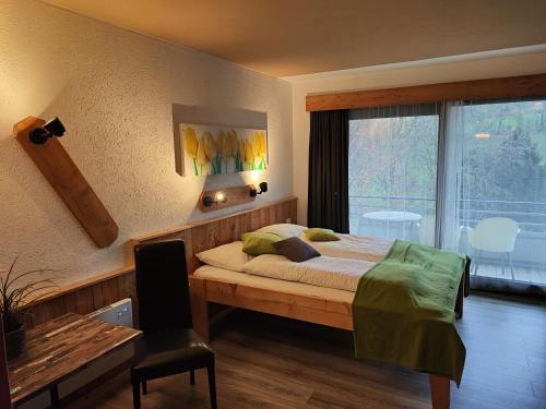 a bedroom with a bed and a desk and a window at Der Engel in Winterberg