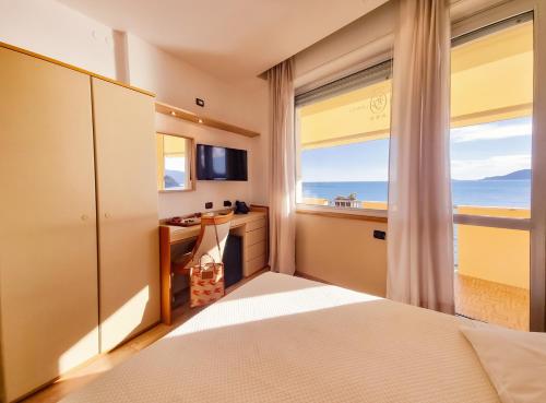 a bedroom with a view of the ocean at Hotel Florida Lerici in Lerici