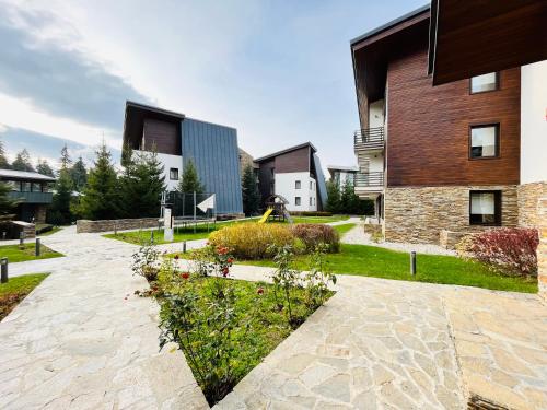 a stone walkway in front of a building at Forest nest - your place to rest! in Borovets