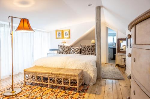 a bedroom with a large bed and a lamp at Family Hotel Okoř in Okoř