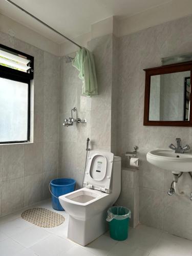 uma casa de banho com um WC e um lavatório em Lumbini Buddha Garden Resort em Rummindei