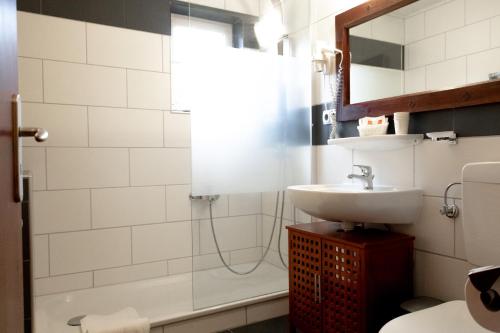 a bathroom with a sink and a shower at Hotel zum See, Titisee in Titisee-Neustadt