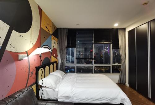 a bedroom with a bed and a large window at River House Near The Peoples Square And The Bund in Shanghai