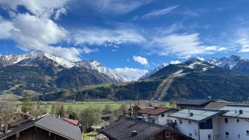 a view of a mountain range with houses and mountains at Select Apartment Top 13by Alpina in Piesendorf