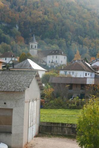 a view of a town with a building and a church at Détente et sport 2 - Chartreuse et Lacs - Chambre chez l'habitant in Saint-Béron
