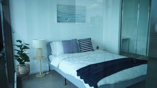 a bedroom with a bed and a blue light at Hidden GEM at Newstead in Brisbane