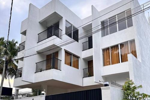 a white building with balconies on the side of it at 2 Bedroom Apartment - Aurora Residences Maharagama in Maharagama