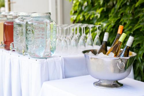 a table with bottles of wine in a bucket at Family Hotel Okoř in Okoř