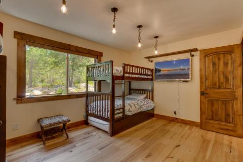 a bedroom with a bunk bed and a window at Hawk's Peak at Tahoe Donner in Truckee