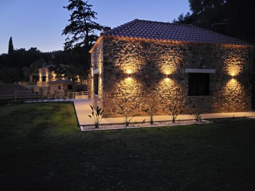 a stone building with lights on the side of it at Aoria Villas in Palaiochóra